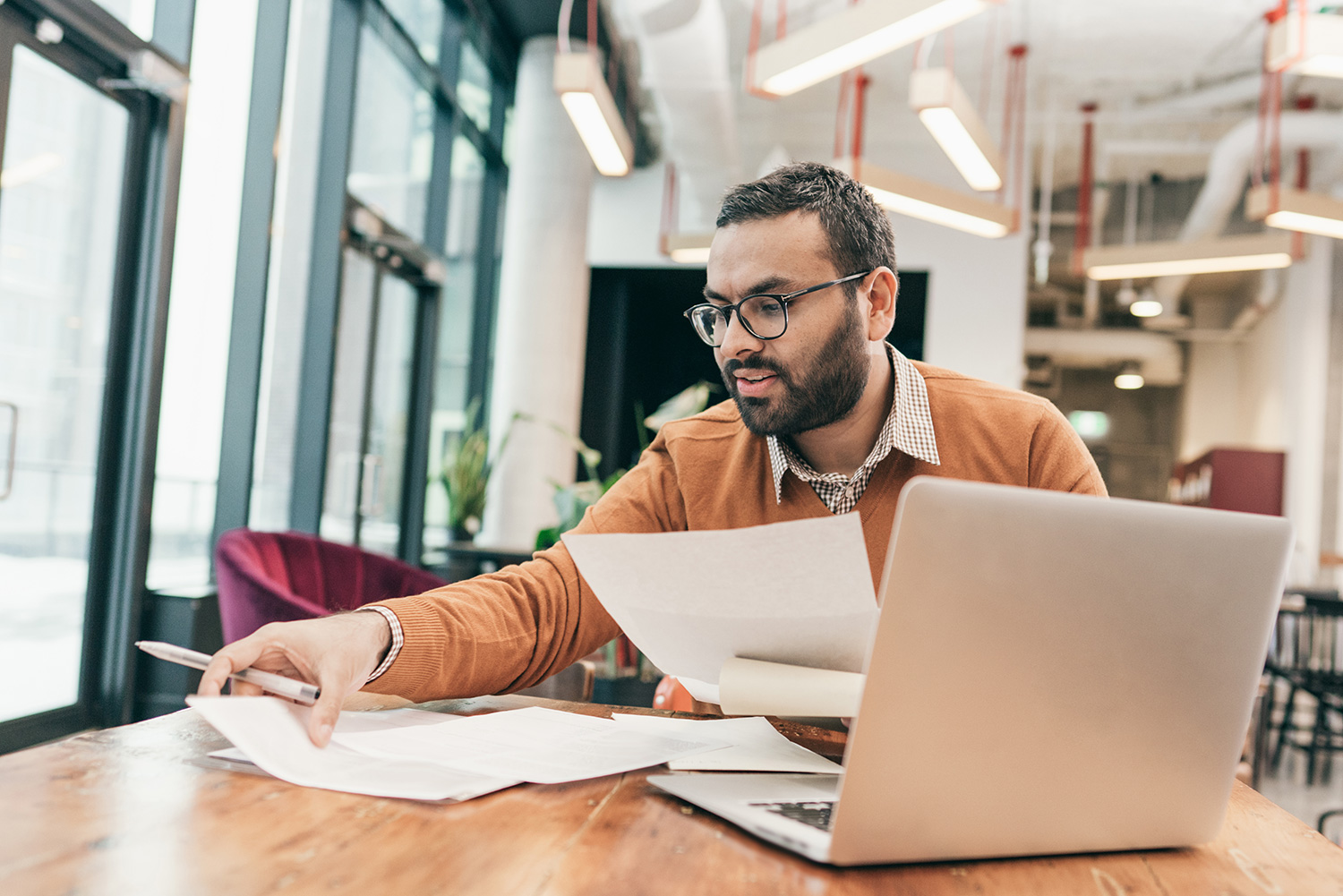 Man in an office looking at document