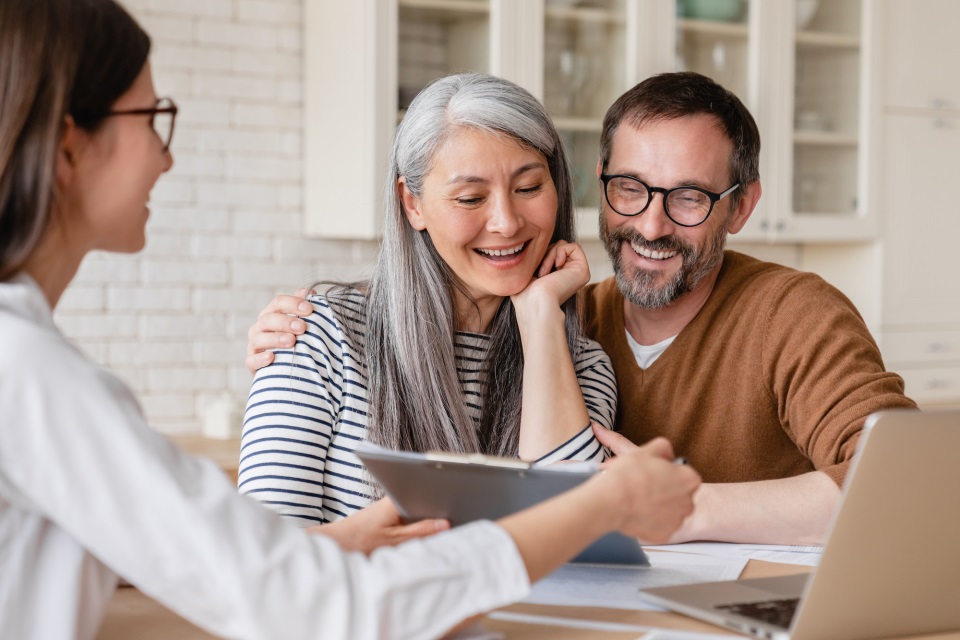 A smiling couple looking at documents